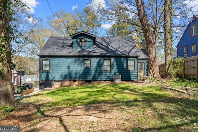 rear view of property with a yard