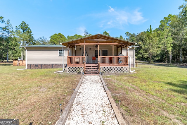 view of front of property featuring a deck and a front lawn