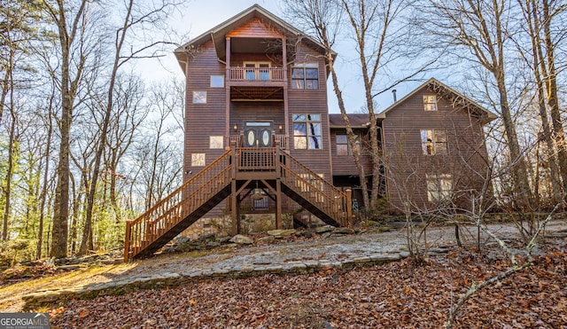 rear view of property featuring a balcony