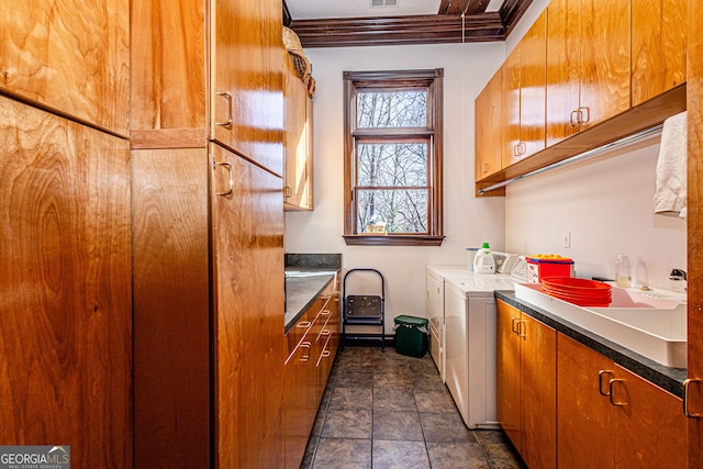 laundry room featuring cabinets and washer and clothes dryer