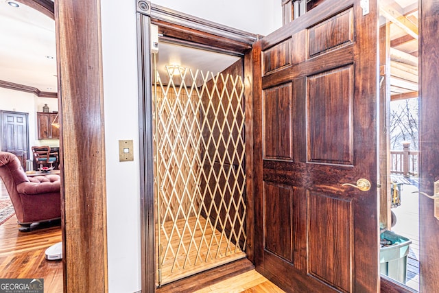 room details featuring wood-type flooring and elevator