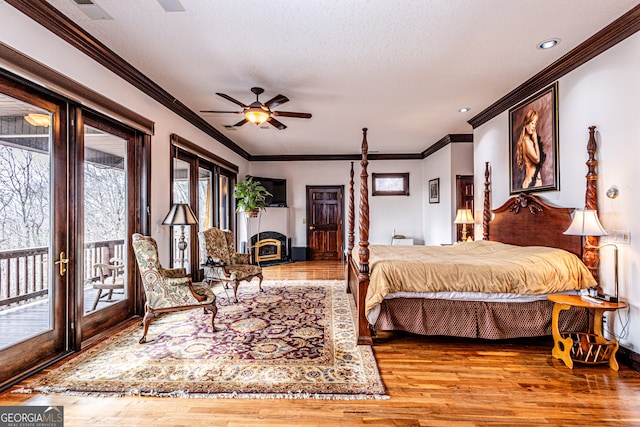 bedroom with wood-type flooring, access to exterior, and ceiling fan