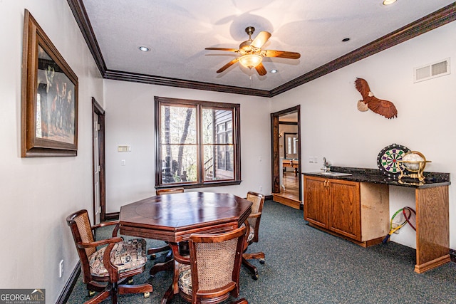 dining area featuring crown molding and ceiling fan