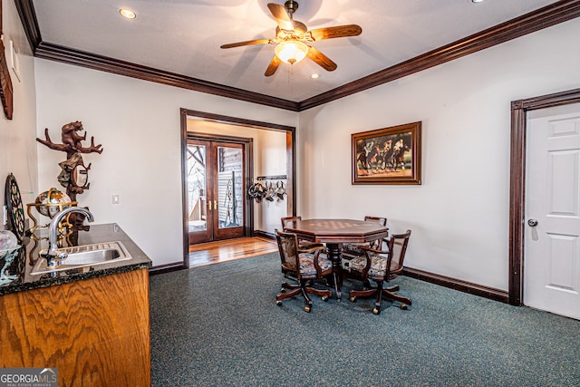 dining room featuring crown molding, french doors, sink, and ceiling fan