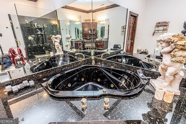 bathroom featuring ornamental molding, vanity, and a tub