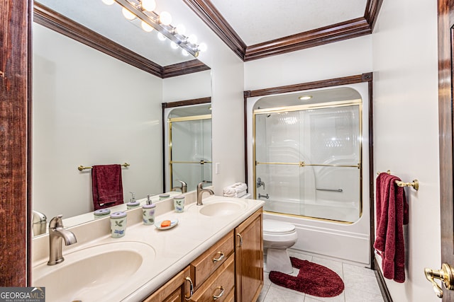 full bathroom with tile patterned flooring, toilet, shower / bath combination with glass door, vanity, and ornamental molding