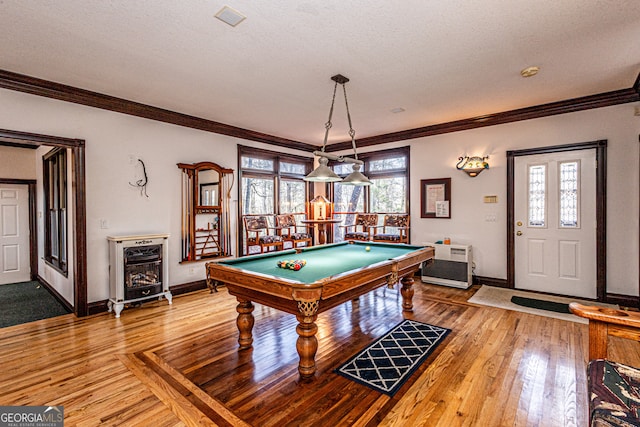 recreation room featuring pool table, crown molding, wood-type flooring, and a textured ceiling