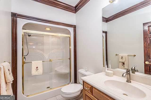 bathroom with crown molding, tile patterned floors, toilet, a shower with shower door, and vanity