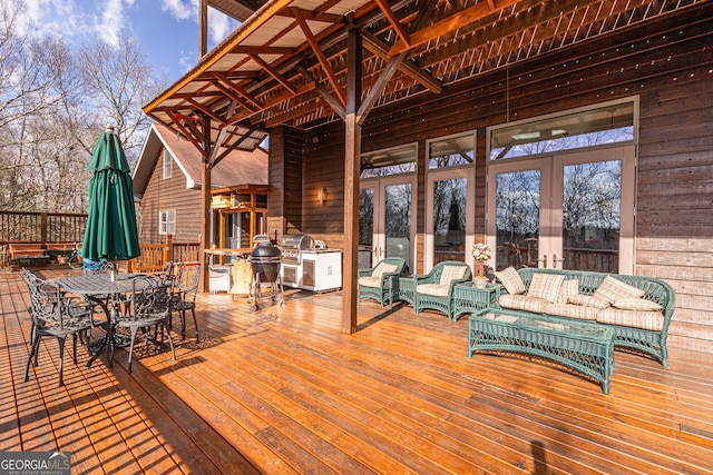 wooden terrace with an outdoor living space