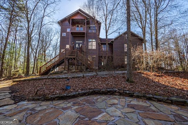 rear view of house with a patio area and a deck