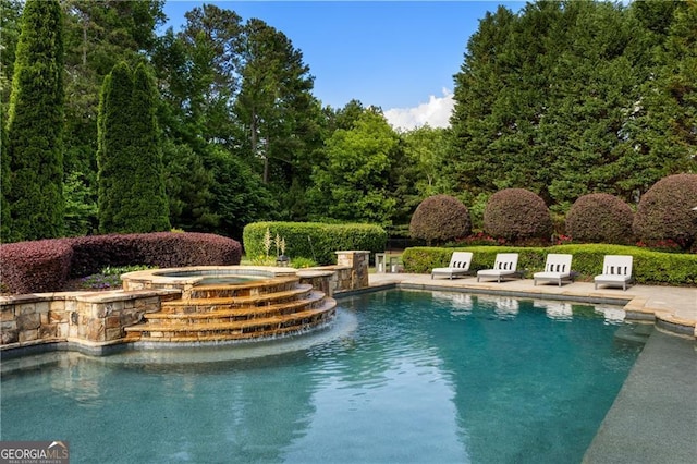 view of pool with an in ground hot tub