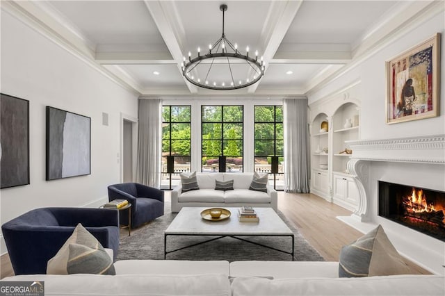 living room with crown molding, an inviting chandelier, light wood-type flooring, and beam ceiling