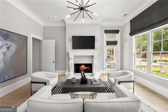 living room featuring crown molding, an inviting chandelier, and hardwood / wood-style flooring