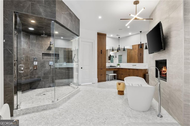 bathroom featuring a fireplace, vanity, tile walls, and shower with separate bathtub