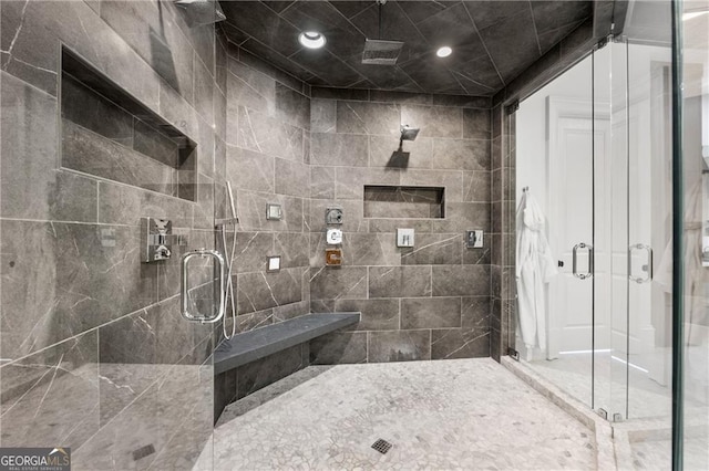 bathroom with a shower with shower door