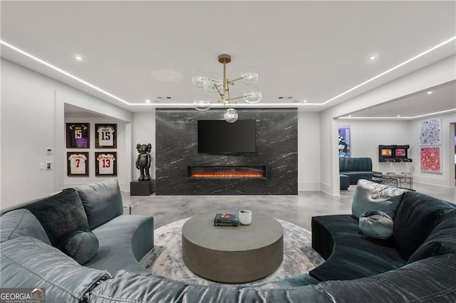 living room featuring a fireplace, a notable chandelier, and concrete flooring