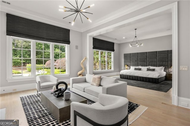 bedroom with crown molding, light hardwood / wood-style floors, and a notable chandelier