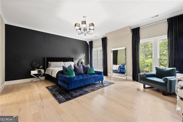 bedroom with light wood-type flooring, multiple windows, an inviting chandelier, and crown molding