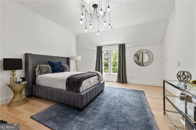 bedroom featuring crown molding, a chandelier, and light hardwood / wood-style floors