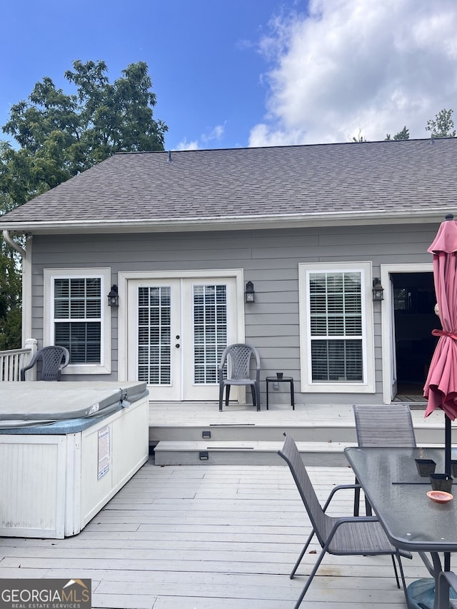 wooden deck featuring french doors and a hot tub