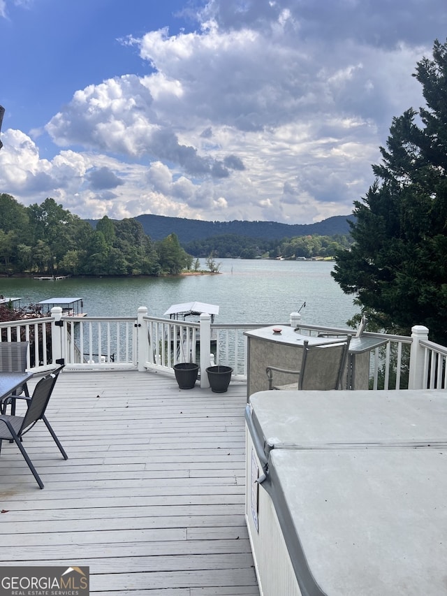 exterior space with a water and mountain view