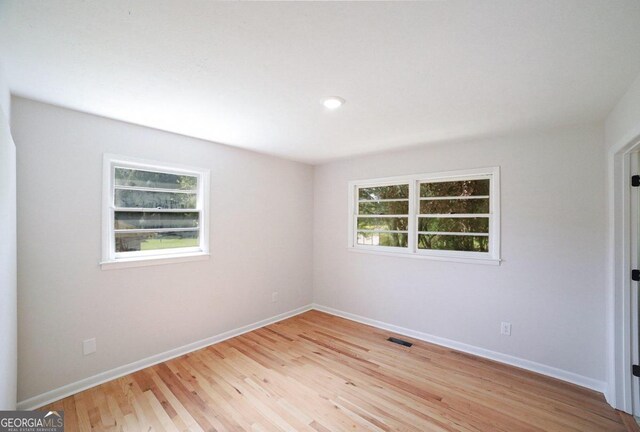 spare room with light hardwood / wood-style floors