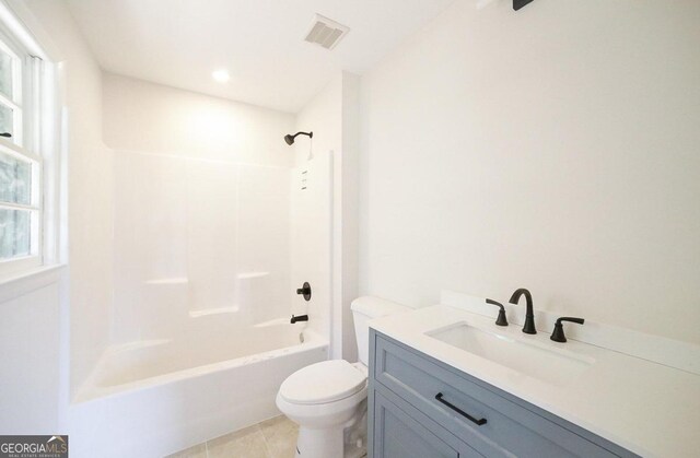 full bathroom with vanity, toilet, plenty of natural light, and shower / washtub combination