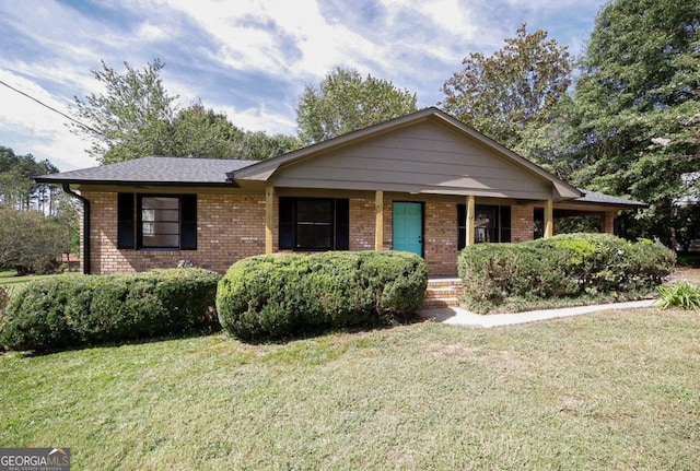 single story home with a porch and a front lawn