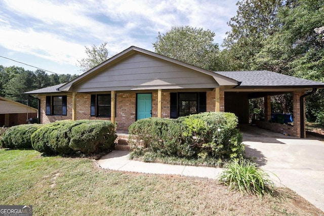 ranch-style home with covered porch, a front lawn, and a carport