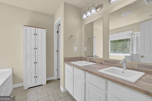 bathroom featuring vanity and a bath