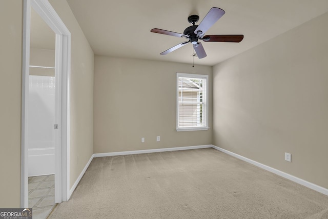 unfurnished room with ceiling fan and light colored carpet