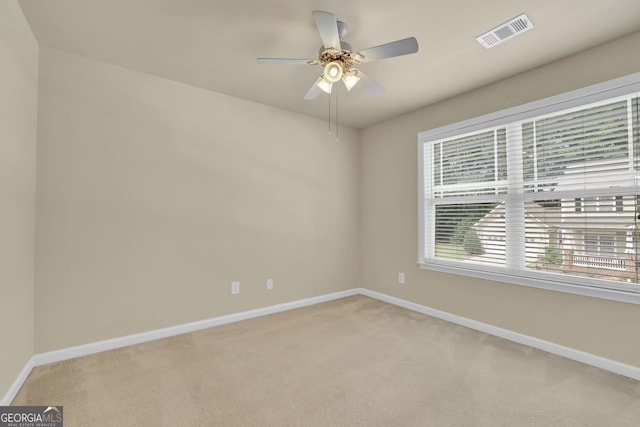 unfurnished room with ceiling fan and light colored carpet