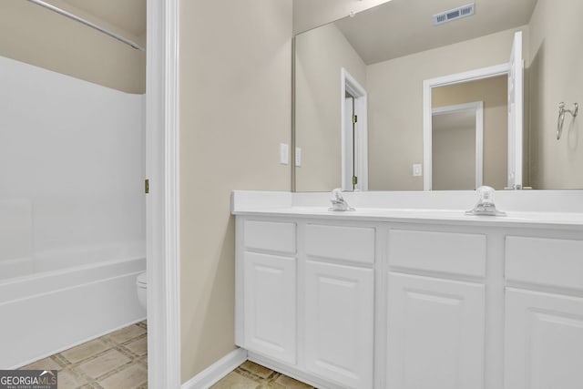 full bathroom with vanity, tub / shower combination, and toilet