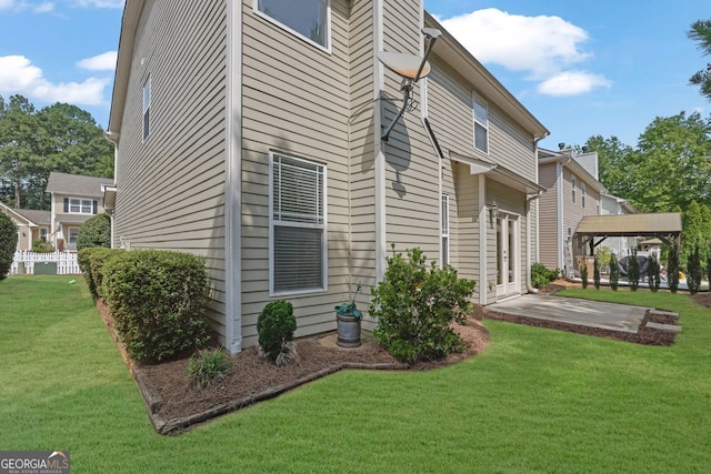 back of property featuring a patio area and a lawn