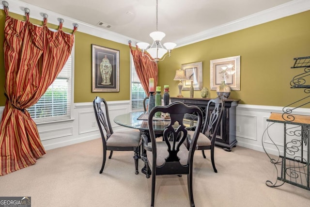 dining room featuring a notable chandelier, plenty of natural light, and crown molding