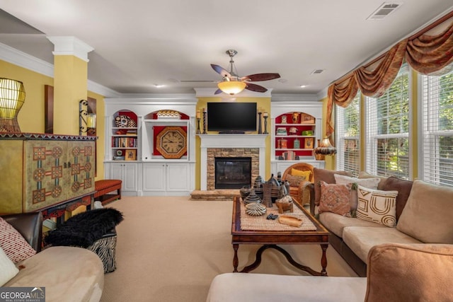 carpeted living room with ceiling fan, a fireplace, and ornamental molding