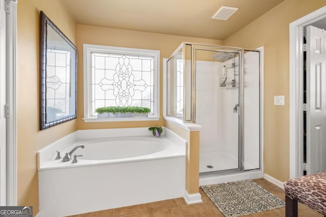 bathroom with shower with separate bathtub and tile patterned floors