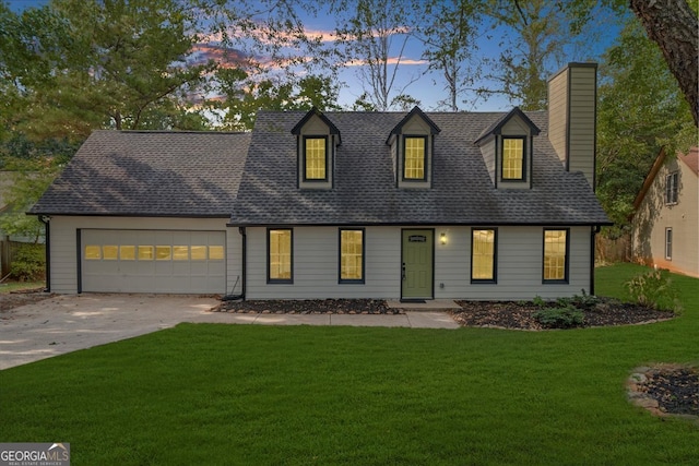 cape cod house with a garage and a lawn