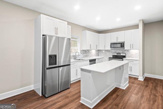 kitchen with white cabinets, dark hardwood / wood-style flooring, stainless steel appliances, and sink