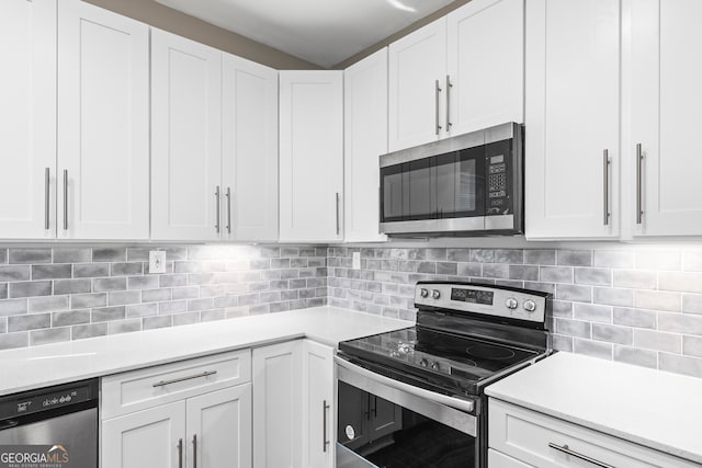 kitchen featuring appliances with stainless steel finishes, tasteful backsplash, and white cabinets