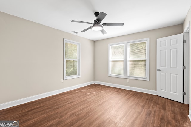 unfurnished bedroom featuring dark hardwood / wood-style flooring and ceiling fan