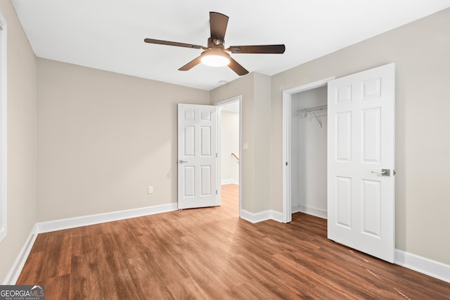 unfurnished bedroom featuring hardwood / wood-style floors, ceiling fan, and a closet