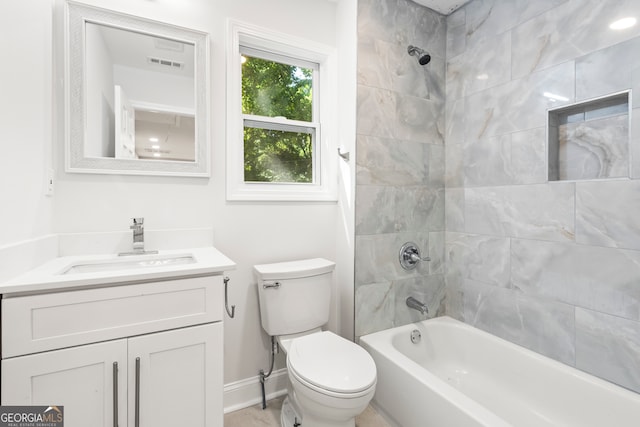 full bathroom with vanity, toilet, and tiled shower / bath combo