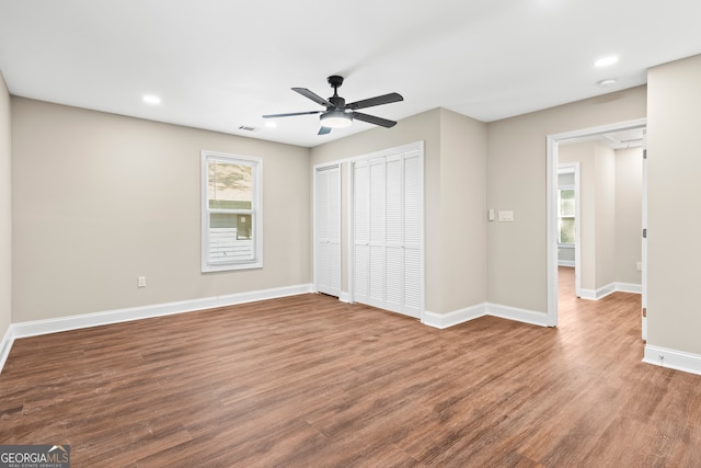 unfurnished bedroom featuring ceiling fan and hardwood / wood-style flooring