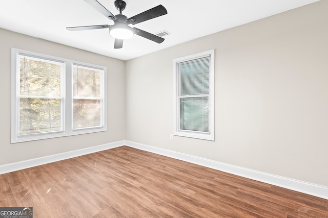 unfurnished room with hardwood / wood-style flooring and ceiling fan