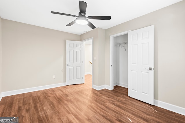 unfurnished bedroom with a closet, ceiling fan, and wood-type flooring