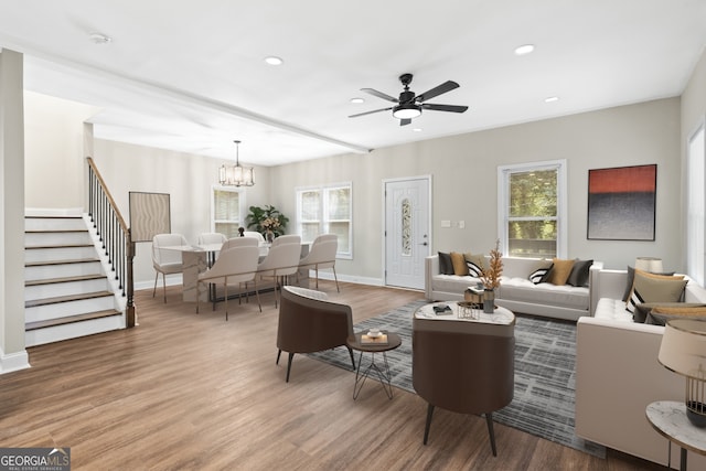 living room featuring ceiling fan with notable chandelier, hardwood / wood-style flooring, and a healthy amount of sunlight