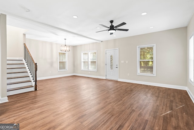 unfurnished living room with hardwood / wood-style floors and ceiling fan with notable chandelier