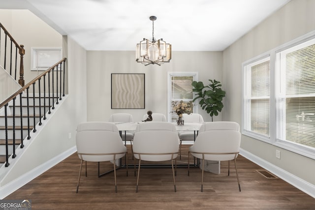 dining area featuring plenty of natural light, a notable chandelier, and dark wood-type flooring