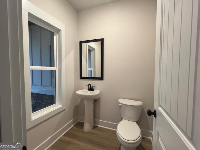 bathroom with sink, hardwood / wood-style floors, and toilet